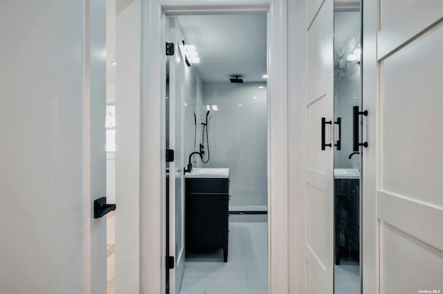 bathroom with vanity and a shower with shower door