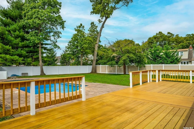 view of swimming pool with a yard, a patio area, and a wooden deck