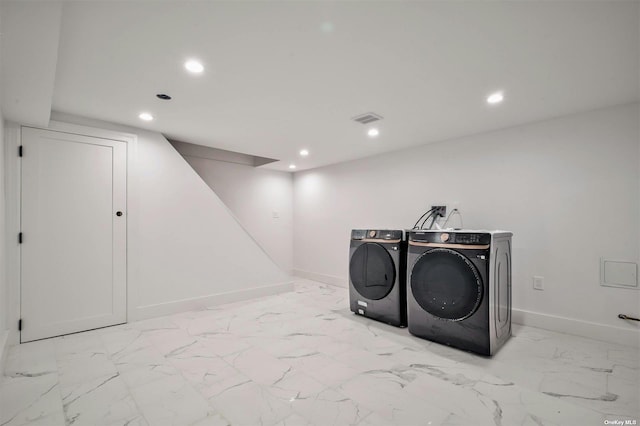 laundry room featuring washing machine and clothes dryer