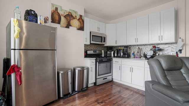 2350 Waterbury Ave, Bronx, NY 10462 - kitchen with stainless steel appliances, white cabinets, backsplash, and dark wood-style floors