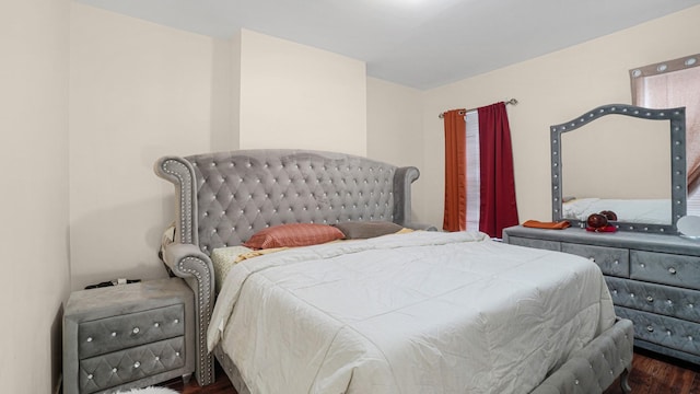 bedroom with dark wood-type flooring