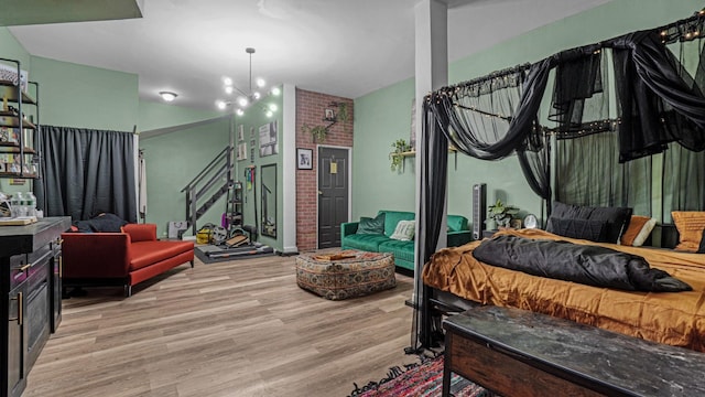 bedroom featuring a chandelier and light hardwood / wood-style flooring