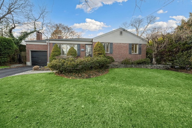 view of front facade with a front lawn and a garage