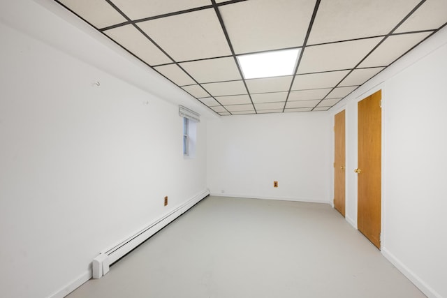 spare room with a paneled ceiling and a baseboard radiator