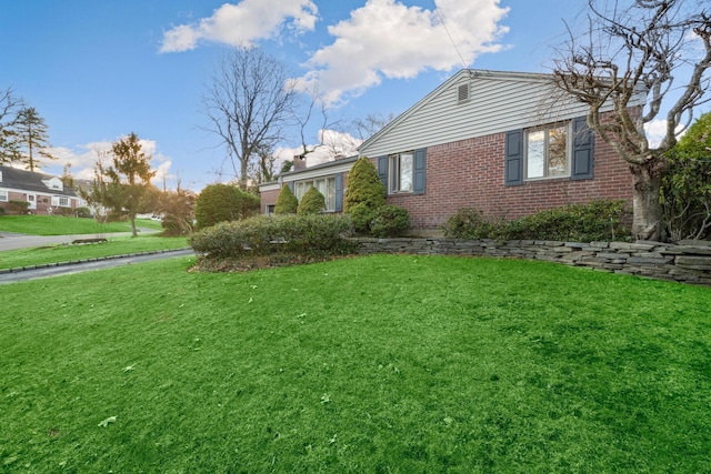 view of property exterior with a lawn