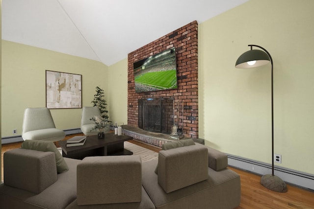 living room with a brick fireplace, hardwood / wood-style floors, a baseboard heating unit, and vaulted ceiling