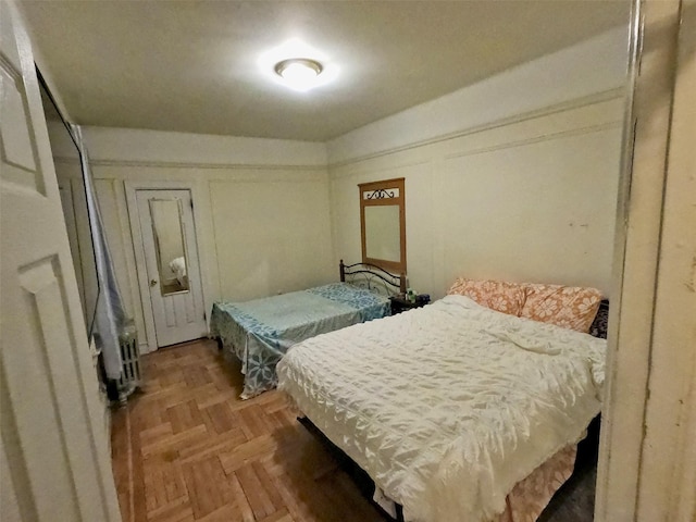 bedroom featuring parquet flooring