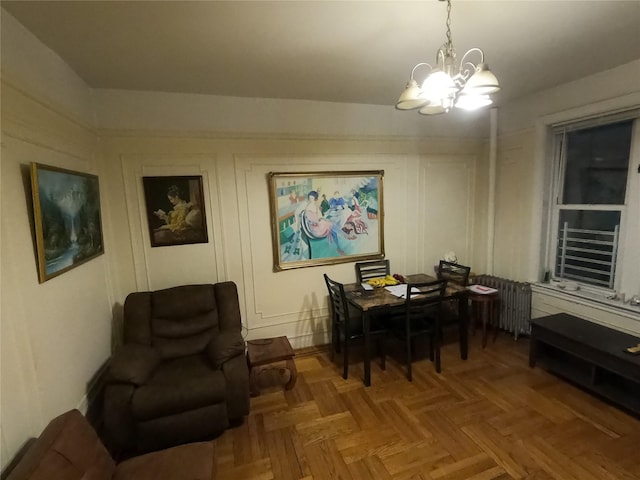 dining space featuring parquet floors and an inviting chandelier