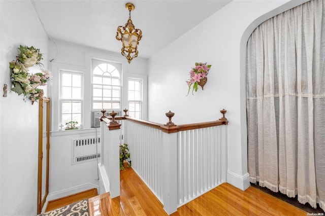 interior space with hardwood / wood-style flooring and radiator heating unit