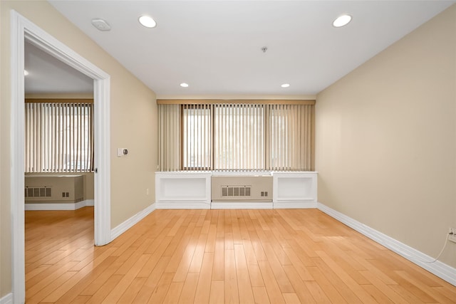 spare room with light hardwood / wood-style floors and a wealth of natural light