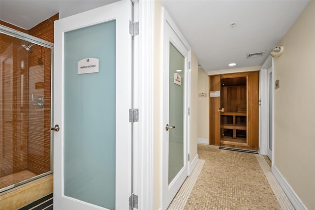 corridor featuring light tile patterned floors