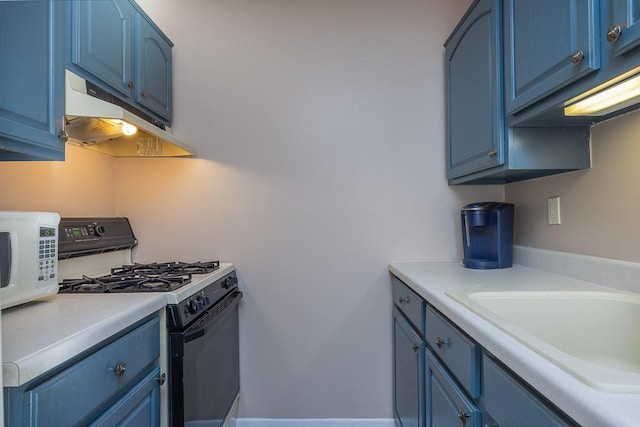 kitchen with sink, range with gas cooktop, and blue cabinetry