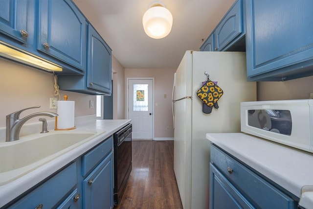 kitchen featuring blue cabinets, dark hardwood / wood-style flooring, sink, and white appliances