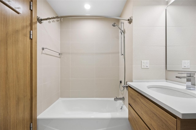 bathroom featuring vanity and tiled shower / bath