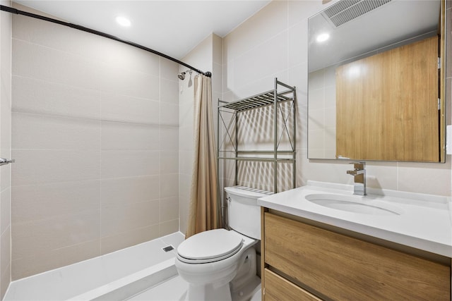 bathroom featuring walk in shower, vanity, tile walls, and toilet