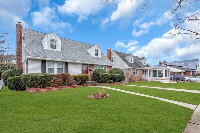 cape cod-style house featuring a front lawn