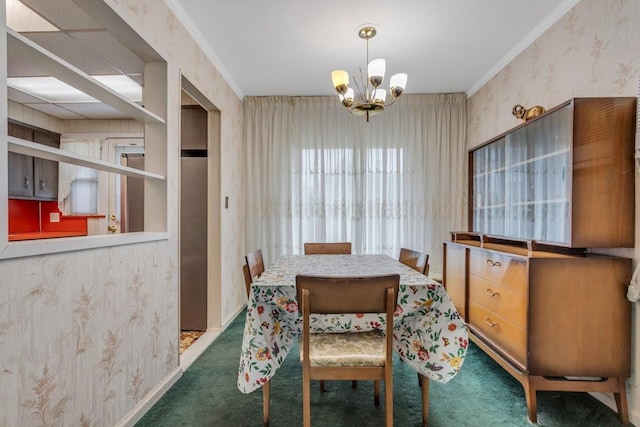 carpeted dining area featuring ornamental molding and a notable chandelier