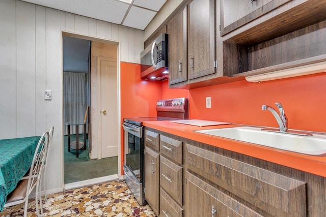 kitchen with sink, stainless steel appliances, and a drop ceiling