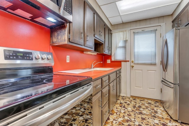 kitchen featuring stainless steel appliances, a drop ceiling, and sink