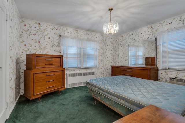 carpeted bedroom with radiator heating unit and a notable chandelier