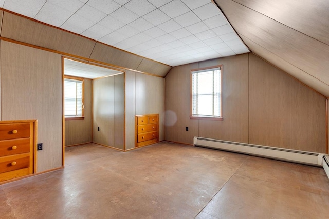 bonus room featuring wood walls, plenty of natural light, a baseboard radiator, and lofted ceiling