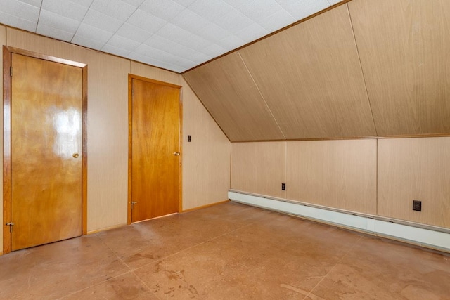 bonus room with a baseboard radiator, lofted ceiling, and wood walls