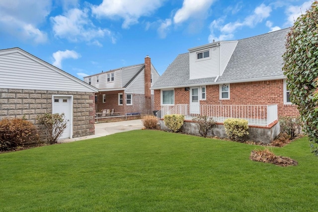 back of house with a lawn