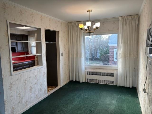 unfurnished dining area with dark colored carpet, a notable chandelier, ornamental molding, and radiator