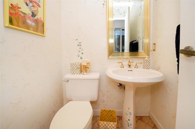 bathroom featuring sink, tile patterned flooring, and toilet