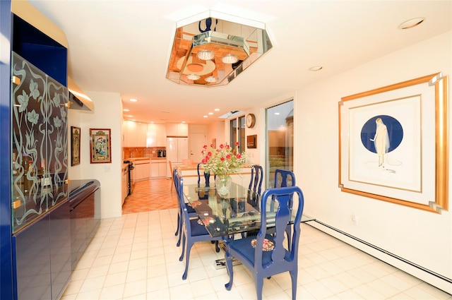 dining space with light tile patterned floors and a baseboard radiator