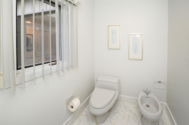 bathroom with toilet and a bidet