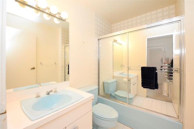 full bathroom with vanity, toilet, and bath / shower combo with glass door