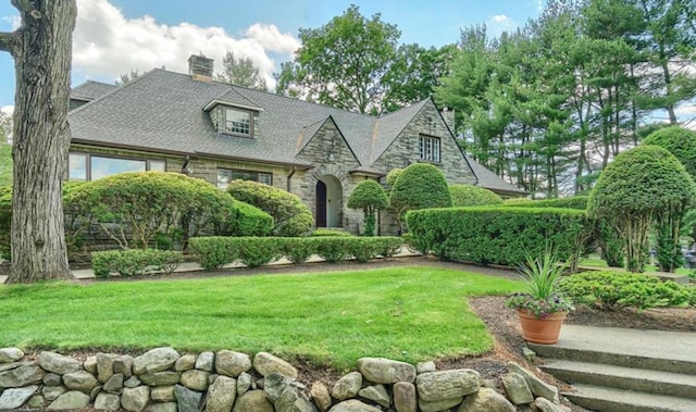 tudor house featuring a front yard