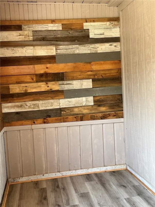 details featuring wood walls and wood-type flooring