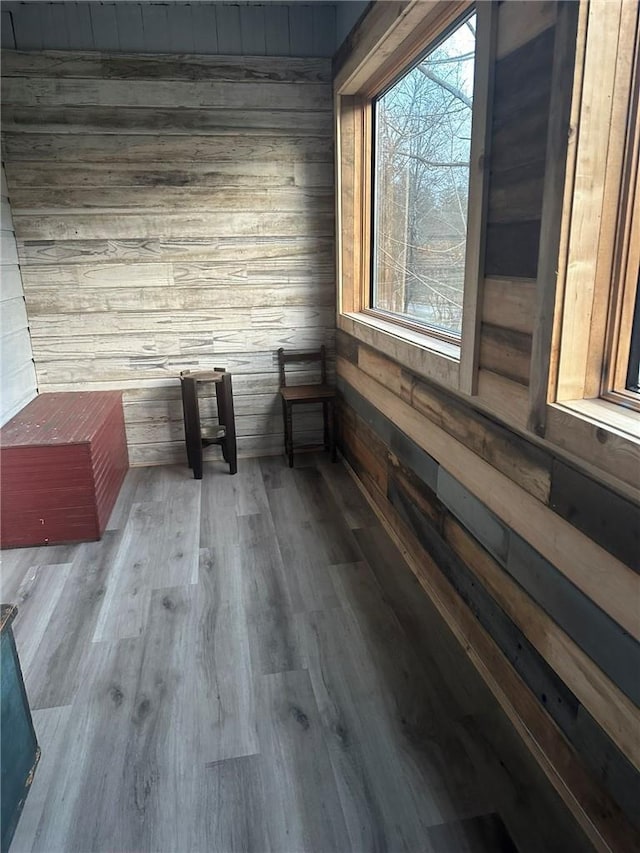 spare room featuring hardwood / wood-style floors and wood walls