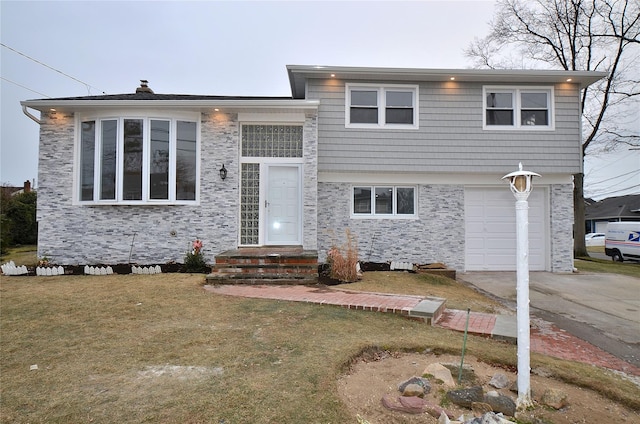 view of front of house with a front lawn and a garage