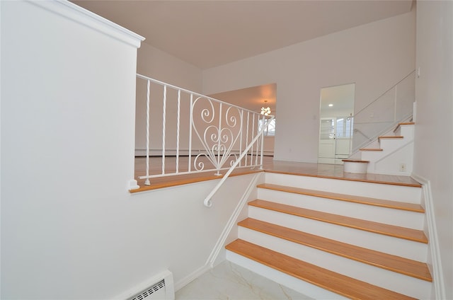 stairway with a notable chandelier