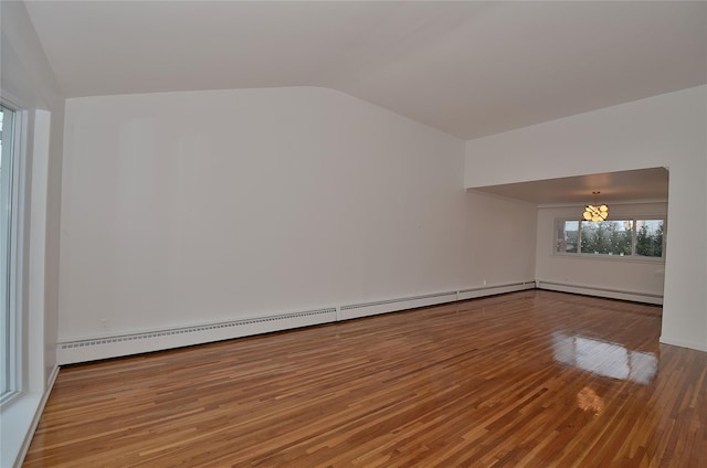 unfurnished room featuring lofted ceiling, light wood-type flooring, a notable chandelier, and baseboard heating