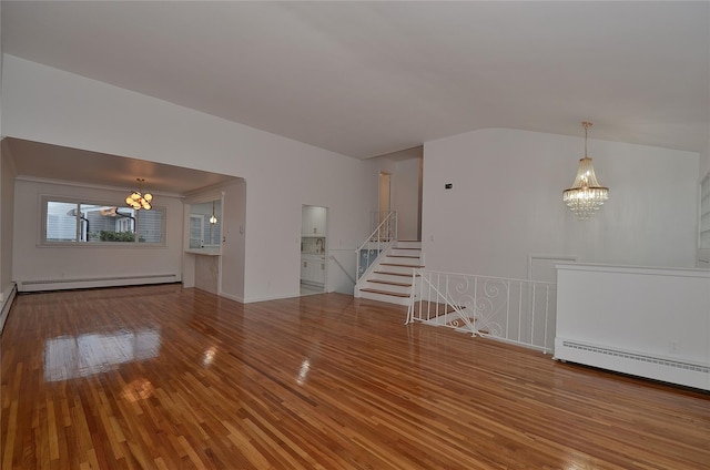 unfurnished living room featuring baseboard heating, wood-type flooring, and a notable chandelier