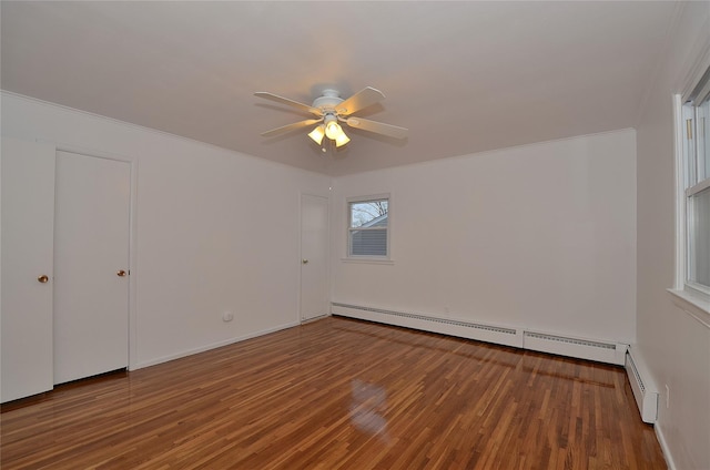 empty room with ceiling fan, hardwood / wood-style flooring, and a baseboard radiator