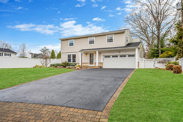 view of front of property featuring a front yard and a garage