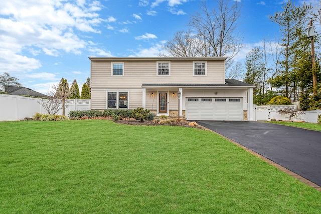 view of front of home with a front lawn and a garage