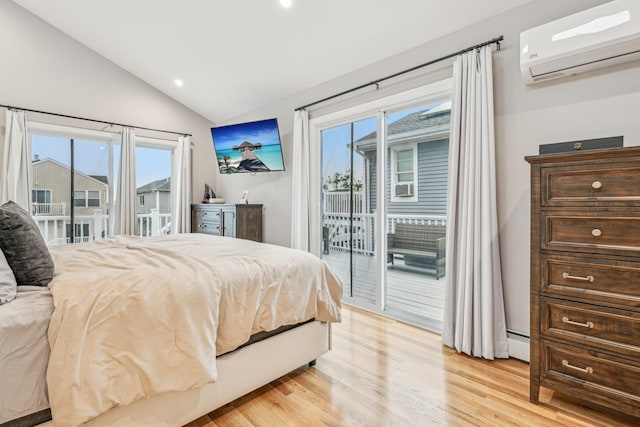 bedroom with vaulted ceiling, a baseboard heating unit, access to outside, light hardwood / wood-style floors, and a wall unit AC