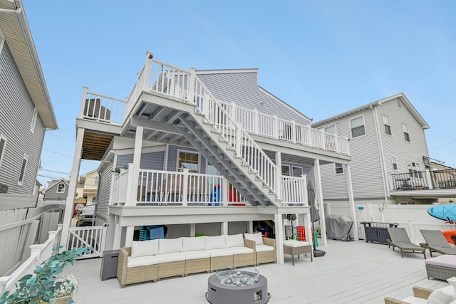 back of property featuring a wooden deck and an outdoor hangout area