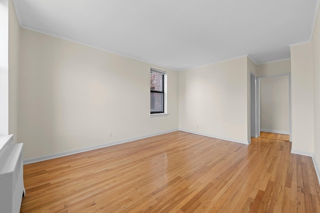 unfurnished room featuring crown molding and light hardwood / wood-style flooring