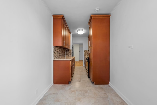 hall featuring ornamental molding and sink