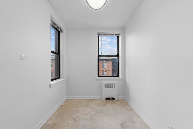 empty room featuring radiator and ornamental molding