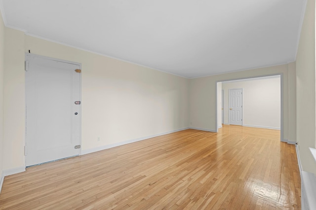 unfurnished room featuring light hardwood / wood-style floors and ornamental molding