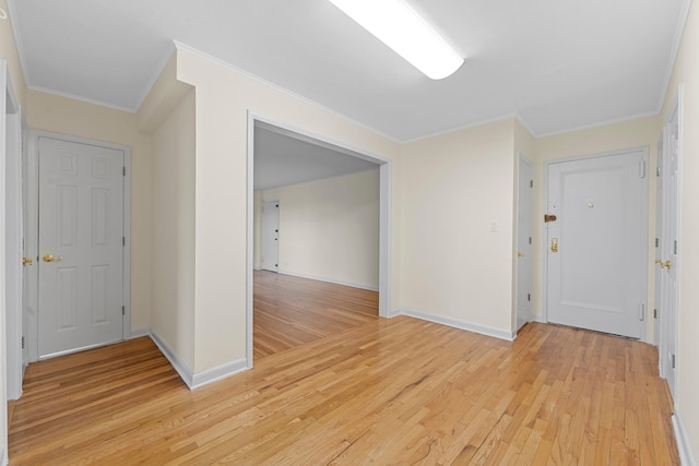 unfurnished room featuring light wood-type flooring and ornamental molding