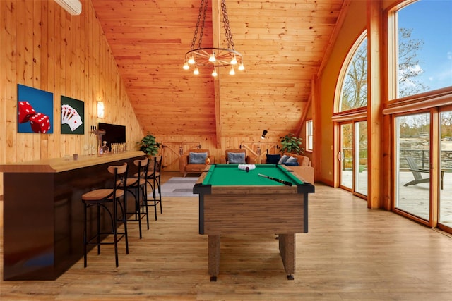 recreation room featuring billiards, high vaulted ceiling, light hardwood / wood-style floors, wooden ceiling, and wood walls